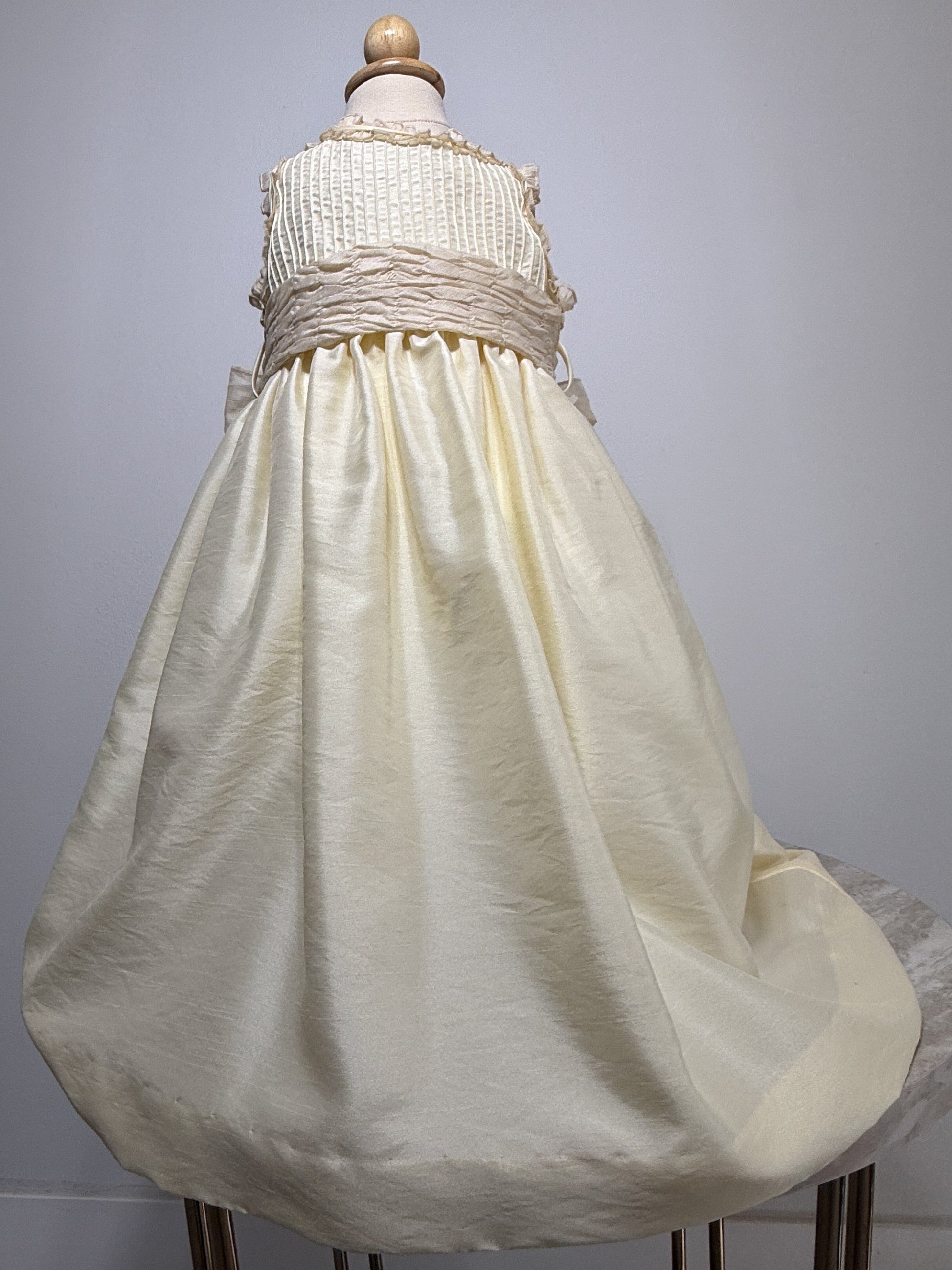 White dress on a mannequin against a gray background