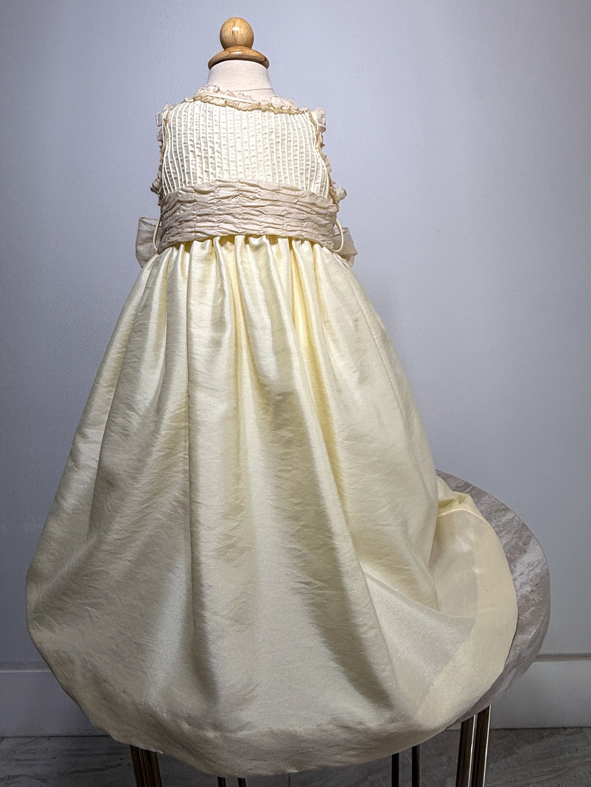 White dress on a mannequin against a gray background