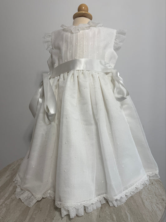 White lace dress on a mannequin against a gray background